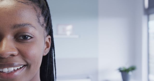 Close-Up of Smiling Woman with Braided Hair in Bright Room - Download Free Stock Images Pikwizard.com