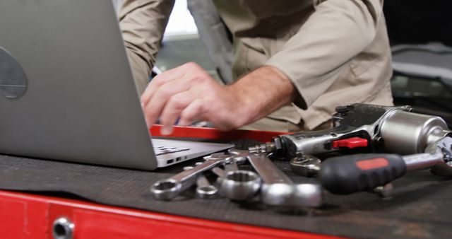 Auto Mechanic Using Laptop to Diagnose Car Issues with Tools on Workbench - Download Free Stock Images Pikwizard.com