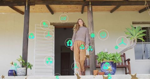 Woman on terrace engaging eco and energy holograms