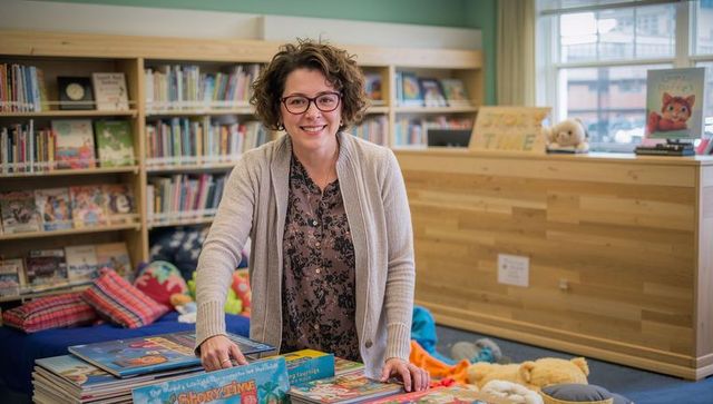 Friendly librarian leading story time in colorful kids corner with books and plush toys