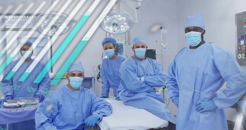 Multicultural surgical team standing in operating room in blue scrubs, masks and gloves