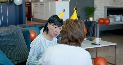 Senior Female Friends Enjoying Birthday Celebration at Home