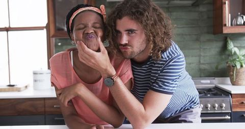 Playful Couple Making Funny Faces in Kitchen
