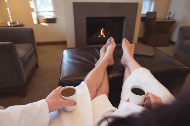 Couple relaxing while having coffee in the living room at home