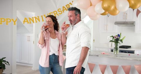 Happy Couple Toasts to Anniversary Celebration at Home