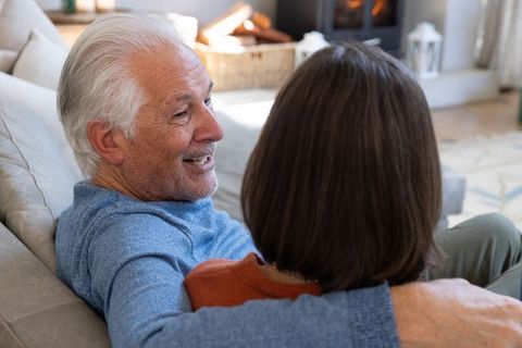 Senior Couple Embracing Warmly on Cozy Living Room Sofa