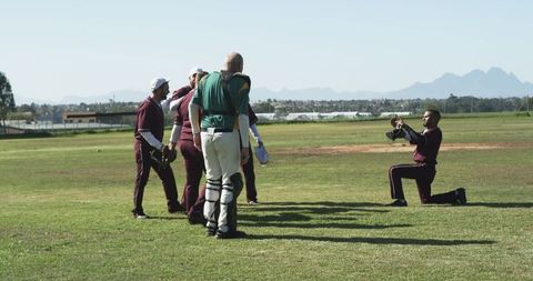 Diverse Cricket Team Posing on Field Captured by Photographer