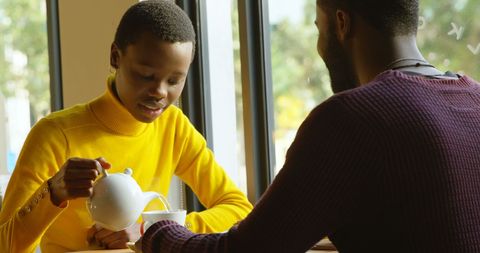 Boy Pouring Tea for Adult Creating Bonding Moment - Download Free Stock Images Pikwizard.com