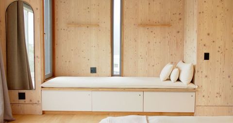 Minimalist interior with built-in bench and wooden paneling