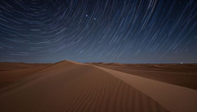 Star Trails Over Tranquil Desert Dunes with Rippled Sands
