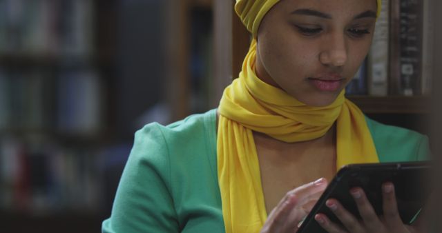 Young Woman in Hijab Using Tablet in Library - Download Free Stock Images Pikwizard.com