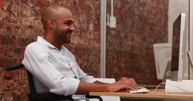 Motivated Businessman in Wheelchair Staying Productive at Office Desk - Download Free Stock Images Pikwizard.com