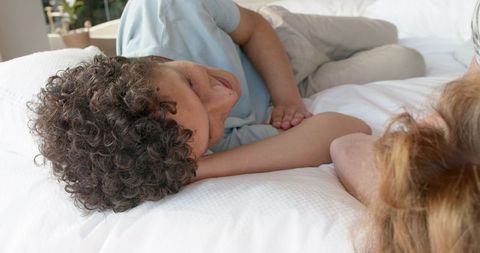 Young Couple Relaxing on Bed in Cozy Home