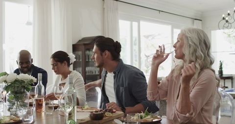 Group of Friends Enjoying Lunch in Bright Dining Room