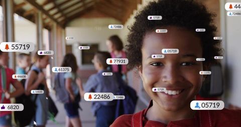 Smiling student with backpack in school corridor with social media notification badges