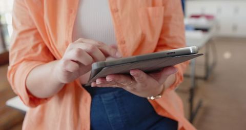 Professional woman using tablet in modern workspace