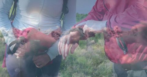 Hikers Checking Smartwatch during Scenic Trek through Meadow