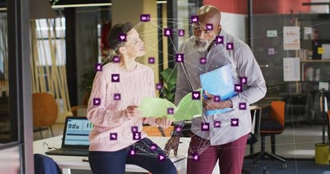 Collaborating Colleagues Reviewing Data and Digital Network Connections in Modern Office