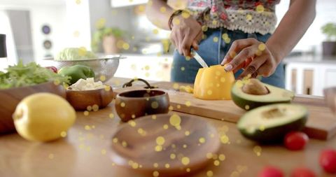 Home cook slicing pepper for fresh rustic meal preparation