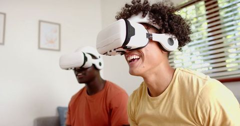 Young Male Friends Enjoying Virtual Reality Experience
