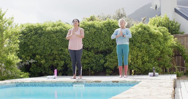 Senior and Mid-Aged Women Practicing Yoga by Outdoor Pool - Download Free Stock Images Pikwizard.com