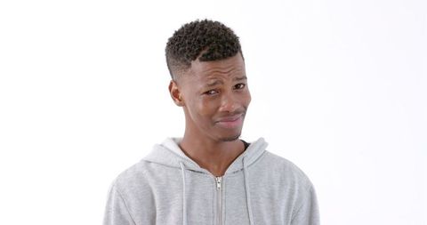 Young Man in Gray Hoodie with Skeptical Expression