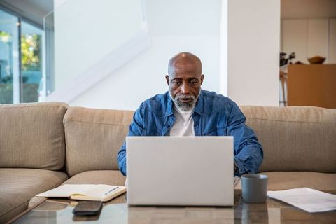 Senior African American Man Working on Laptop in Cozy Home Environment
