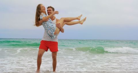 Joyful Vacation Couple Embracing at Serene Beach
