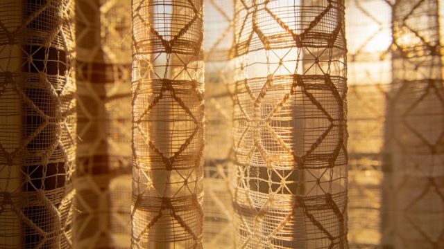 Glowing lace curtains catching golden sunlight and casting geometric star patterns