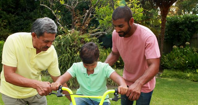 Multi-Generational Family Teaching Child to Ride Bike in Backyard - Download Free Stock Images Pikwizard.com