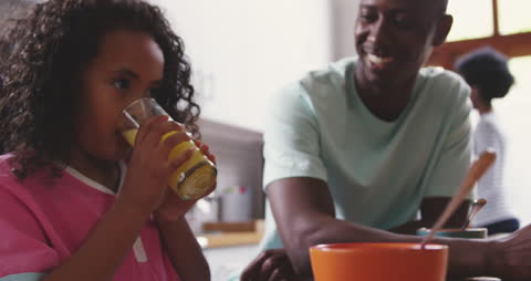 Family Morning Bonding with Breakfast and Juice in Kitchen