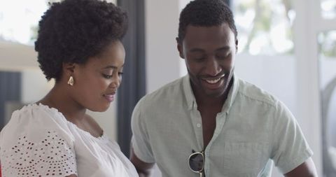 Friends chatting and using smartphone for home discussions