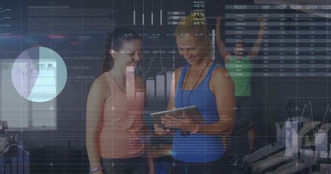 Gym trainer and client examining interactive fitness data