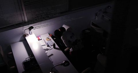 Colleagues collaborating over projected code in late night office