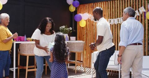 Family Celebrating Birthday with Lively Dance and Joyful Decorations