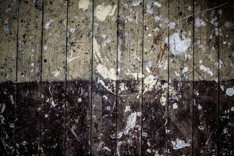 Vintage wooden floor with paint splatters and wear marks