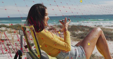 Woman Relaxing at Beach Analyzing Data on Smartphone