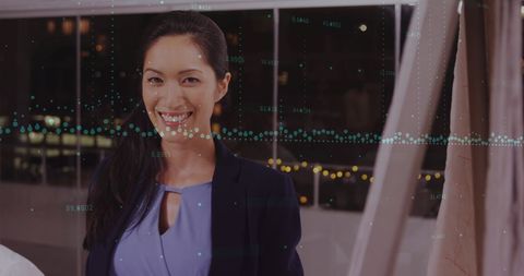 Woman in Office Analyzing Financial Data Visualization