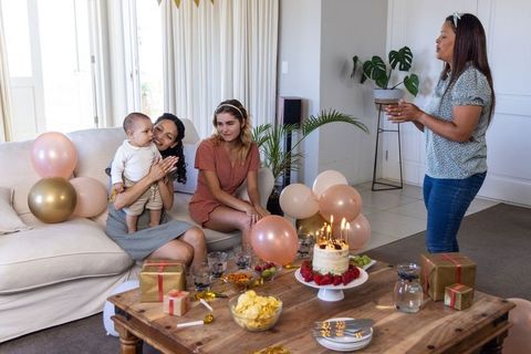 Family Celebrating Birthday with Cake and Gifts at Home