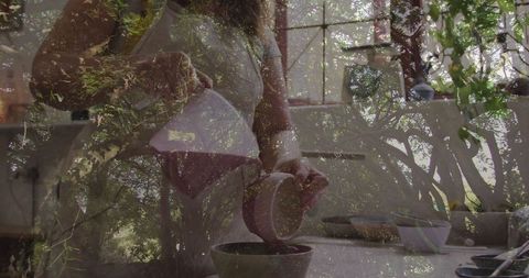 Woman pouring coffee from ceramic carafe in bright kitchen