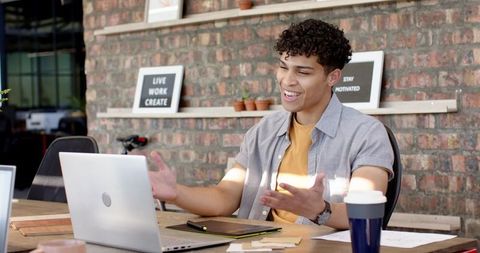 Young Professional Conducting Online Meeting in Contemporary Workspace