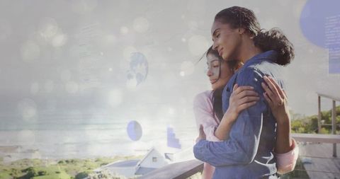 Relaxed bonding mother and daughter on scenic ocean balcony