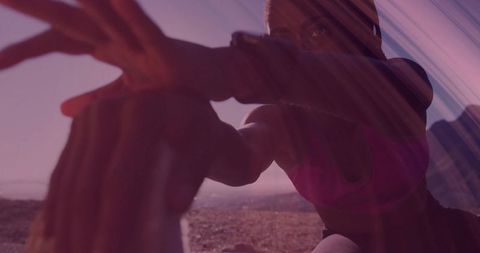 Determined woman in vibrant sportswear stretching outdoors