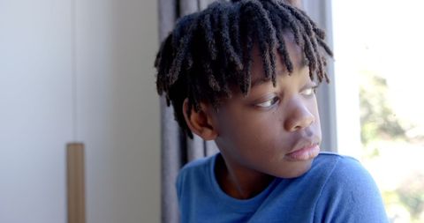 Thoughtful Boy Gazing Out Window