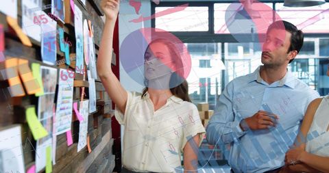 Creative team collaborating on office presentation