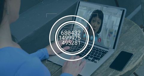 Woman typing on laptop with virtual HUD overlay for remote collaboration and video call