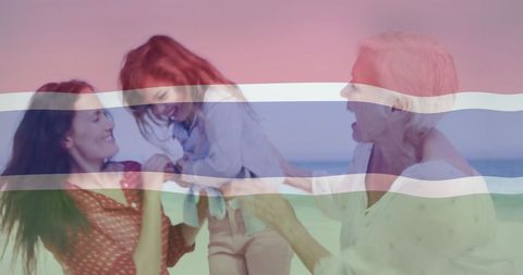 Three Generations of Women Enjoying Calm Beach Vacation