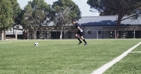 Soccer Player Preparing Kick on Sunny Field