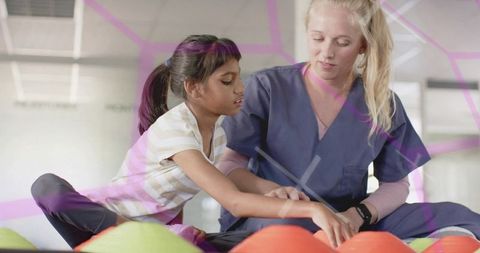 Pediatric therapist guiding child arm movement during playful rehabilitation session