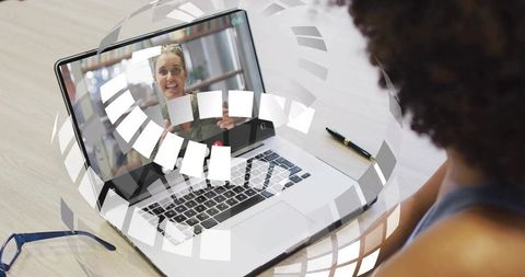Attending virtual webinar on laptop with smiling presenter and interactive overlay
